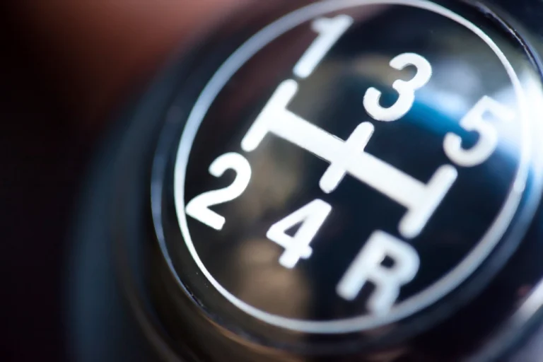 Close-up of a manual car gear stick, linked to clutch replacement