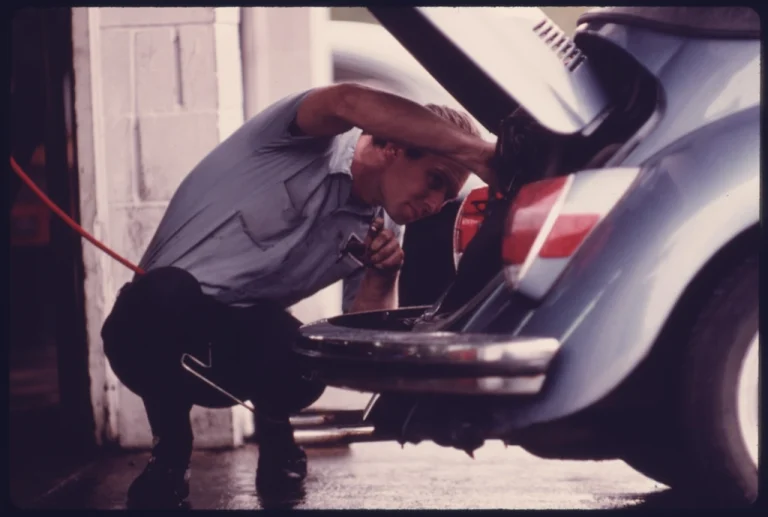 Mechanic working on a car engine during an oil and filter change